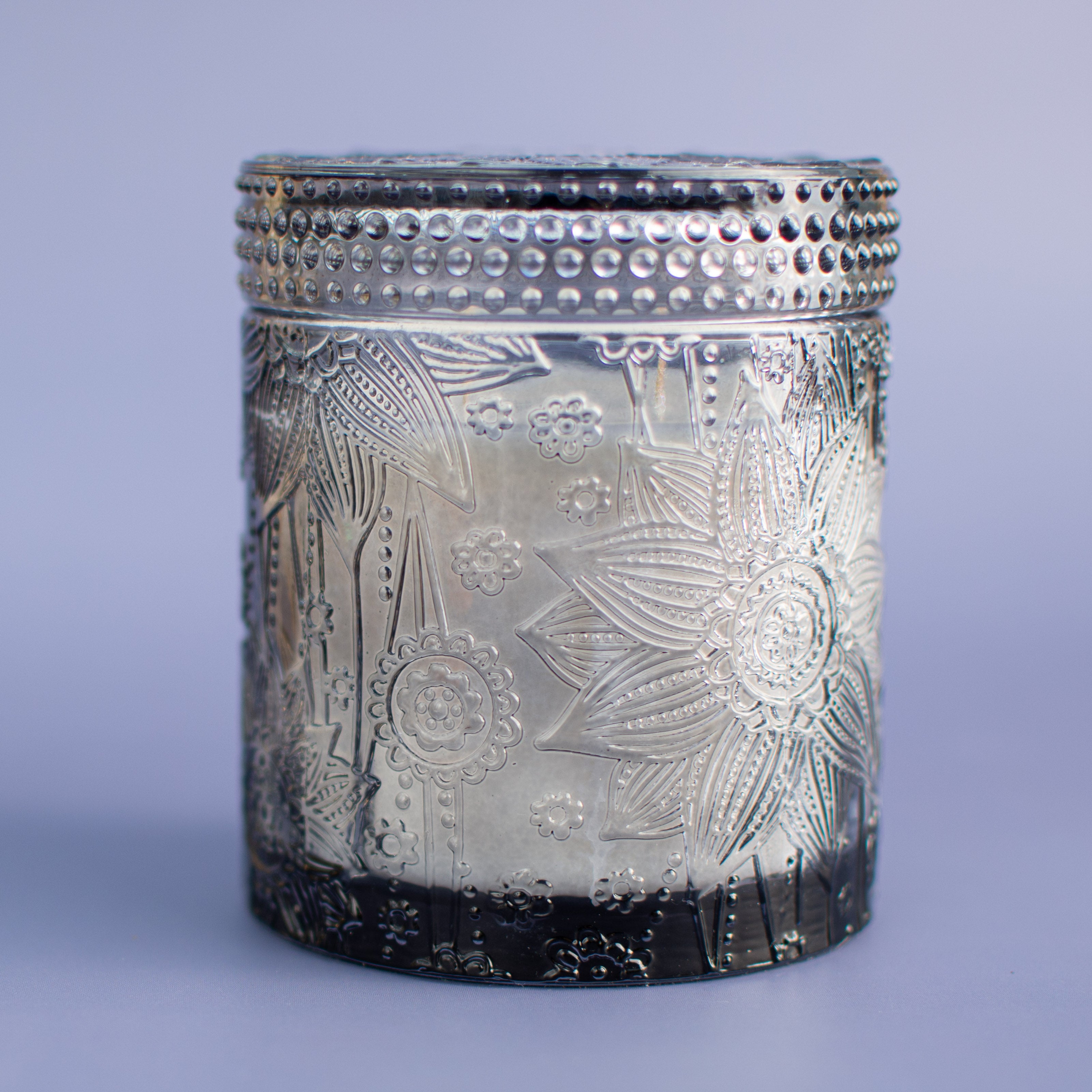 The Ubud unscented candle in embossed smoky black glass vessel with lid by Unscented Candle Company